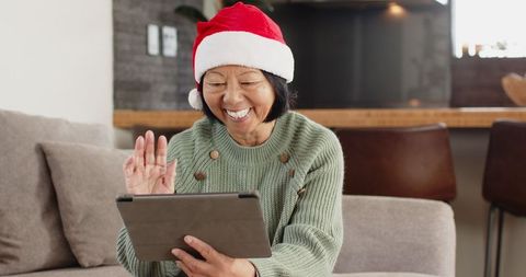Senior woman celebrating festive season with online video call