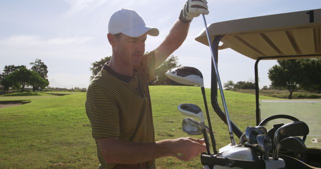 Male Golfer Preparing Golf Clubs at Course Edge - Download Free Stock Images Pikwizard.com