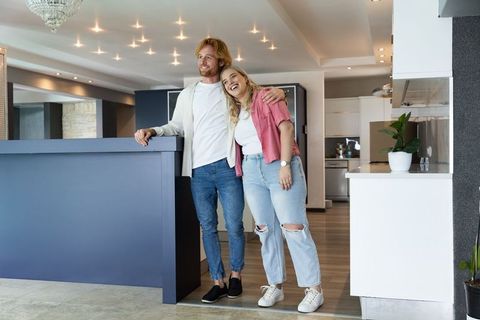 Smiling Couple Enjoying Modern Kitchen Interior Decor