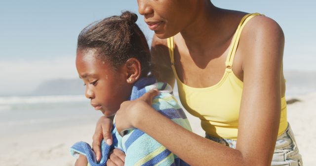 Mother Consoling Daughter on Sunlit Beach Day - Download Free Stock Images Pikwizard.com