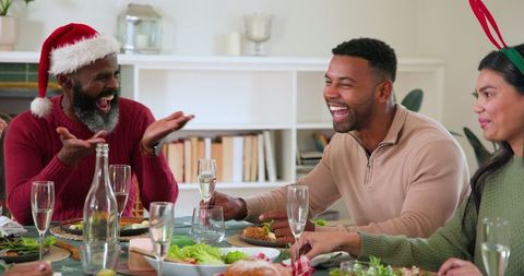 Diverse Family Celebrating Holiday Meal with Joy and Laughter