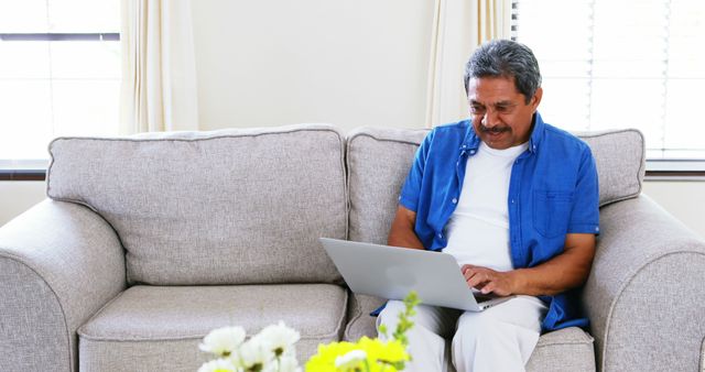 Senior Man Using Laptop at Home on Couch - Download Free Stock Images Pikwizard.com