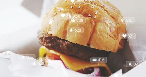 Glossy cheeseburger closeup with social media overlay showing engagement icons