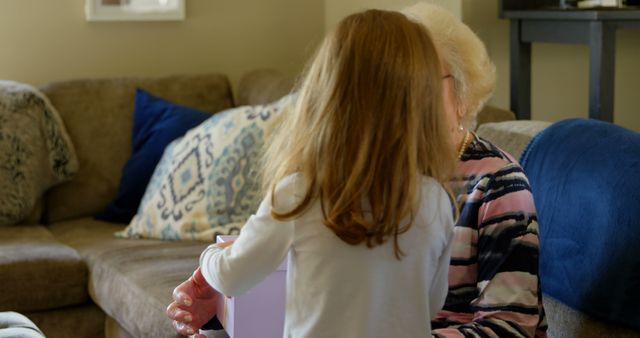 Grandchild Spending Quality Time with Grandparent in Cozy Living Room - Download Free Stock Images Pikwizard.com