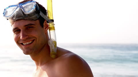 Man Smiling with Snorkeling Gear by the Sea