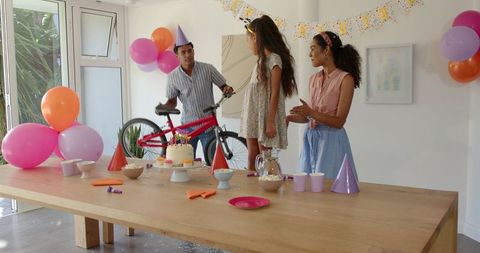 Family birthday celebration with cake and gift at home