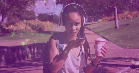 Woman Enjoying Coffee and Music in Park Outdoors