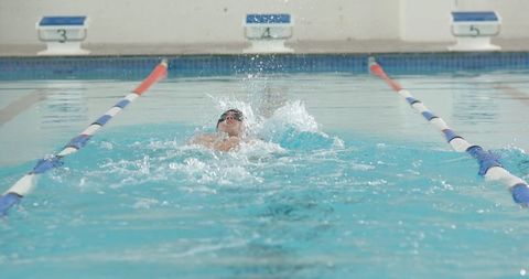 Athlete practicing freestyle stroke in indoor pool