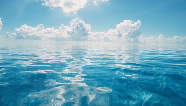 Serene Ocean Under Cloud-Speckled Sky