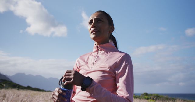 Woman Hydrating During Outdoor Exercise in Countryside - Download Free Stock Images Pikwizard.com