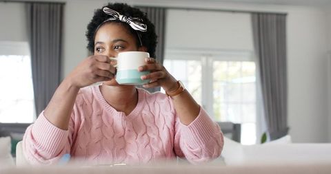 Relaxed Woman Enjoying Coffee at Home in Comfortable Morning