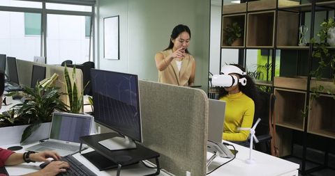 Coworkers Engaging in VR Technology in Contemporary Office Environment