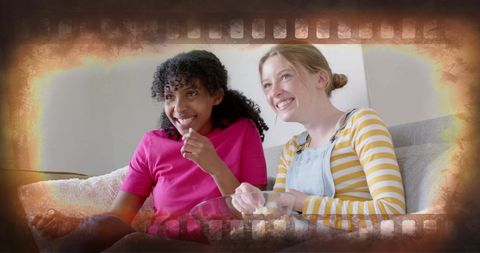 Diverse teenagers enjoying movie night with popcorn overlay