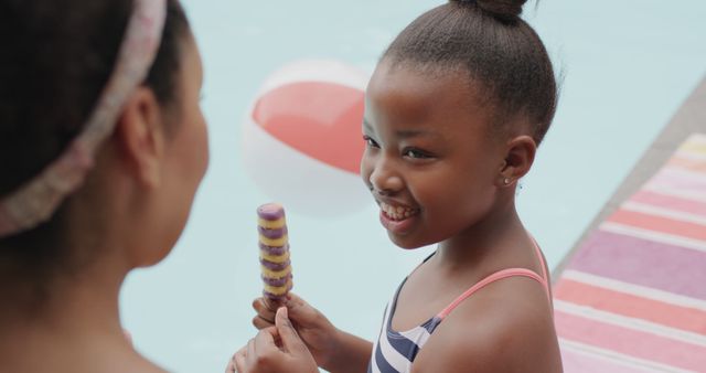 Smiling Girl Eating Popsicle by Poolside with Woman - Download Free Stock Images Pikwizard.com