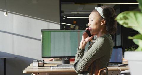 Confident Woman Using Smartphone in Modern Corporate Office