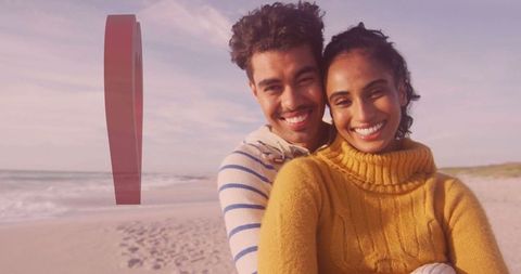 Cheerful Couple Embracing on Serene Beach at Sunset