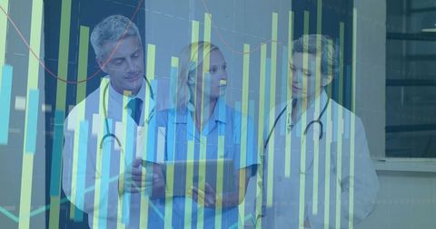 Healthcare Team Analyzing Data in Hospital Corridor