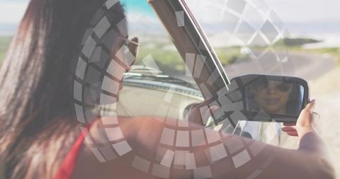 Indian woman checking side mirror driving vintage car near coast with circular overlay