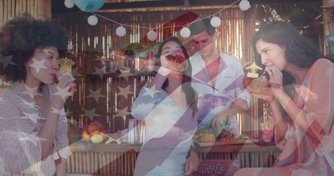 Friends sipping coconut cocktails at tiki bar with bartender cutting pineapple and us flag overlay