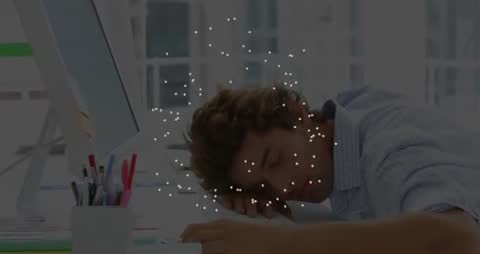 Man Sleeping at Desk with Surreal Floating Particles