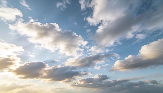 Sunlit Layered Cumulus Clouds Over Blue Sky Golden Hour Panorama