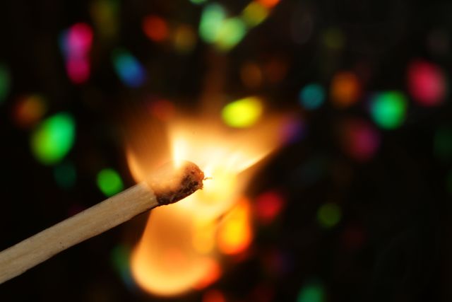 Close-up of Burning Matchstick with Colorful Bokeh in Background - Download Free Stock Photos Pikwizard.com