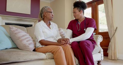Compassionate Nurse Supporting Elderly Woman with Care at Home