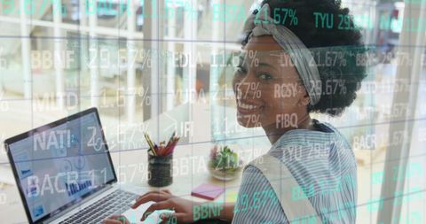Woman analyzing financial data on laptop with trading board overlay