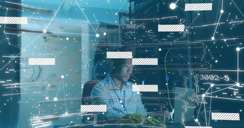 Cybersecurity analyst monitoring digital network in server room