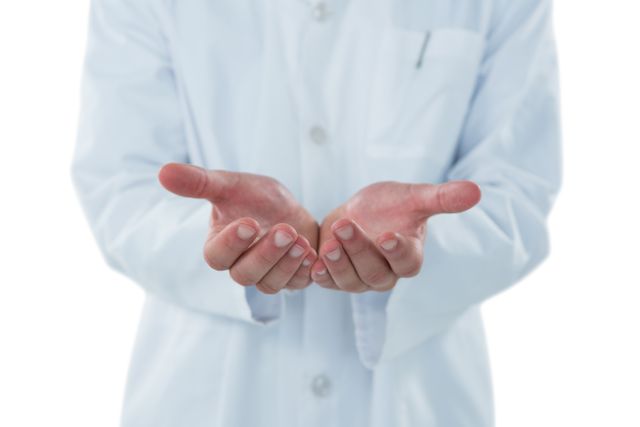 Mid-section of male doctor gesturing against white background