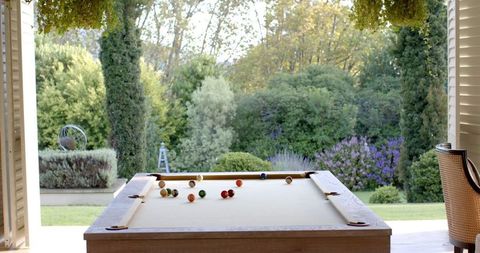 Scenic View of Billiard Table by Open Window with Sunlight
