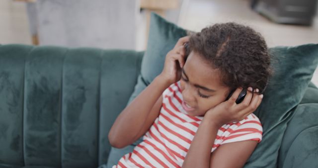 Young Girl Enjoying Music with Headphones on Couch - Download Free Stock Images Pikwizard.com