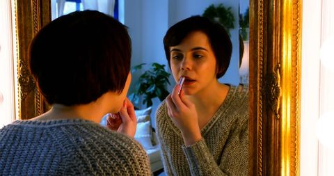 Woman Applying Lipstick in Front of Mirror Reflective Scene - Download Free Stock Images Pikwizard.com