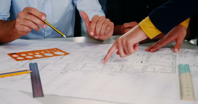 Architects Discussing Building Plans at Office Desk - Download Free Stock Images Pikwizard.com