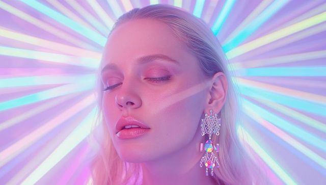 Fashion Model in Neon Light with Vibrant Crystal Earrings