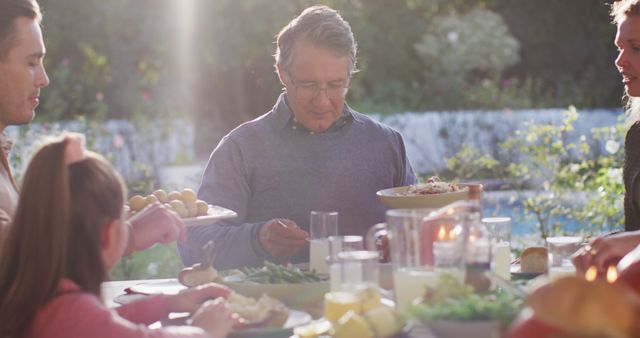 Multigenerational Family Enjoying Outdoor Dinner Together at Sunset - Download Free Stock Images Pikwizard.com