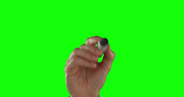 A hand is shown making a pinching gesture against a green screen background, with copy space. The green screen allows for easy replacement of the background in post-production for visual effects.