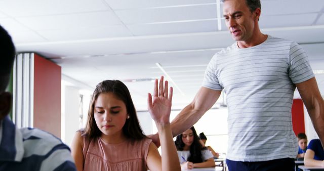 Male Teacher Supporting Female Student in Classroom - Download Free Stock Images Pikwizard.com