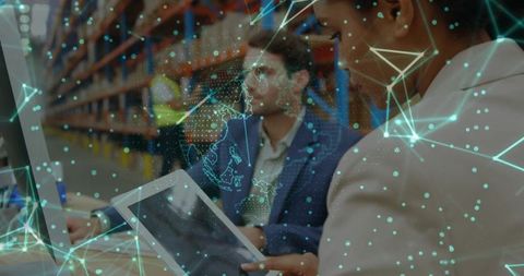 Collaborating Logistics Team Analyzing Data in Warehouse Setting