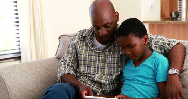 Father and Son Learning Together with Tablet on Couch - Download Free Stock Images Pikwizard.com