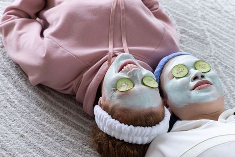 Cozy at-home spa night for friends wearing face masks and cucumber eye slices
