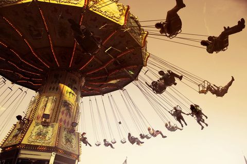 Vintage Carousel Swing Ride at Sunset Featuring Riders