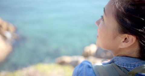 Woman Trekking Enjoying Ocean View in Scenic Destination