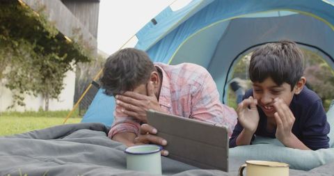Father and Son Enjoying Outdoor Leisure Time with Tablet