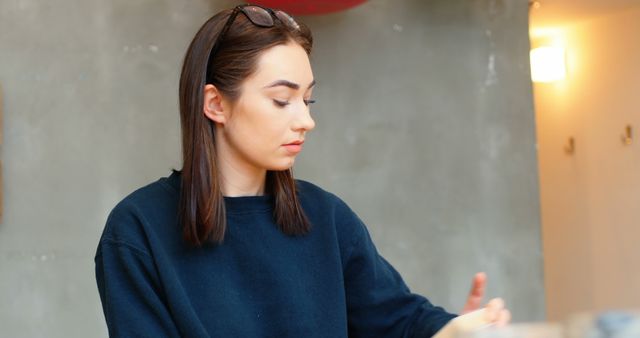 Young Woman Concentrating on Task Indoors - Download Free Stock Images Pikwizard.com