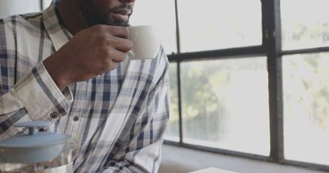 Man Enjoying Coffee Break by Office Window