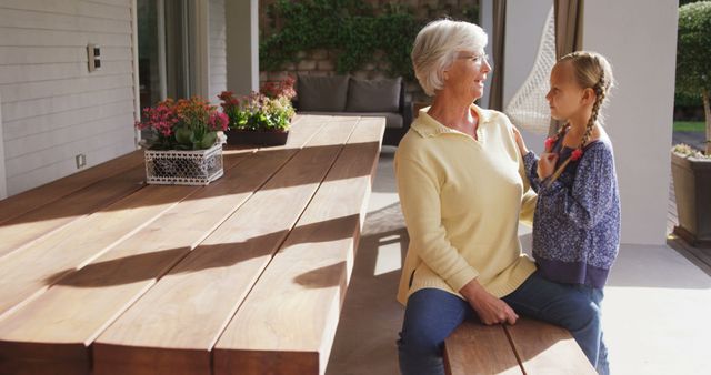 Grandmother and Granddaughter Sharing a Moment on Patio - Download Free Stock Images Pikwizard.com