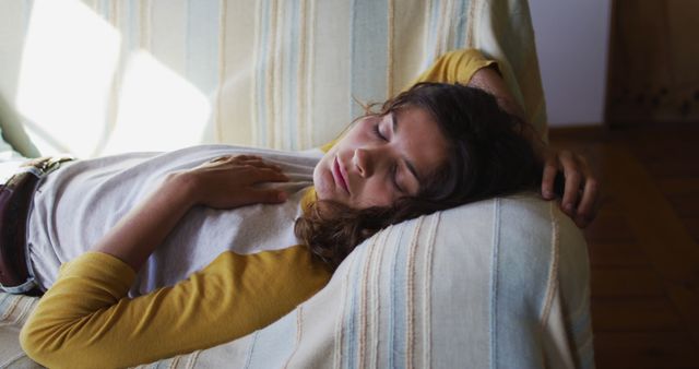 Young woman peacefully sleeping on a comfortable couch - Download Free Stock Images Pikwizard.com