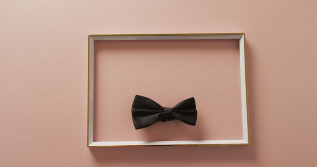 Close up of frame and bow tie on beige background. studio shot, food autumn and celebration concept.