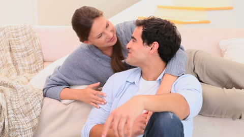 Smiling Couple Relaxing in Living Room, Expression of Warm Companionship